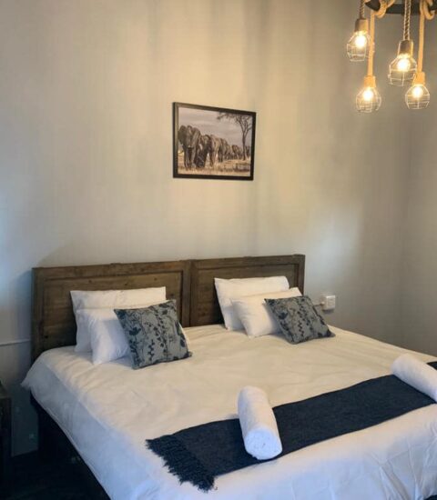 double bed in bedroom of claassens safaris