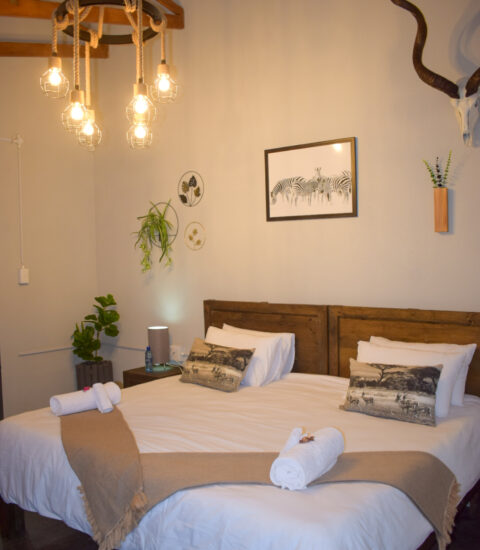 gallery with double bed at claassens safaris