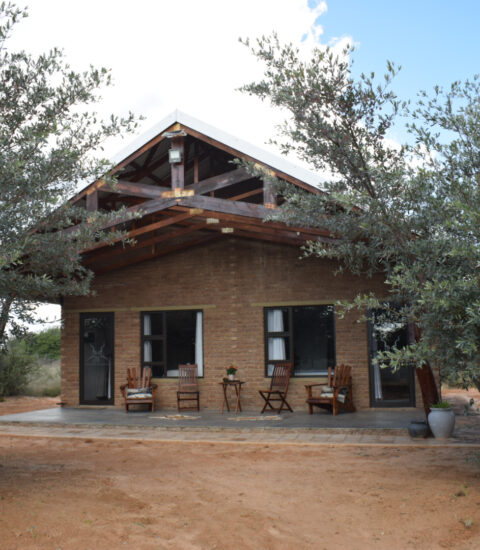 gallery with entrance of the rooms at Claassens Safari with chairs