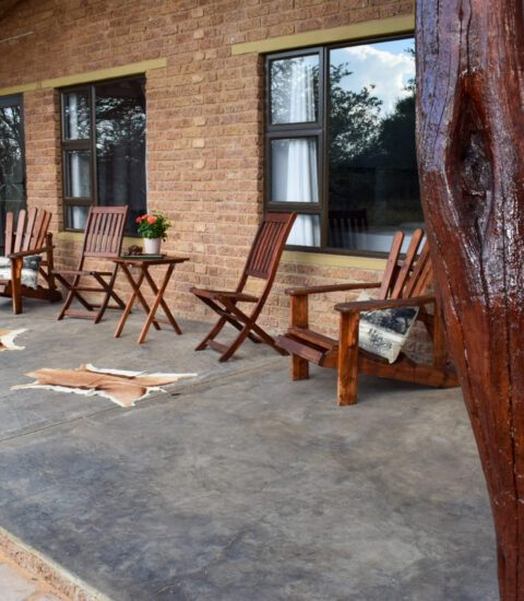 gallery with close up of entrance of the rooms at Claassens Safari with chairs