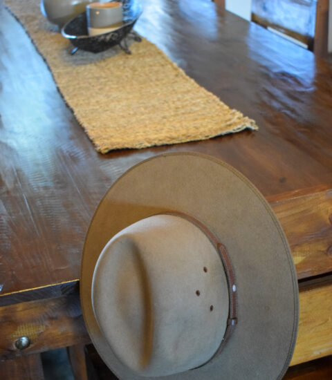 dining table with hat hanging off chair