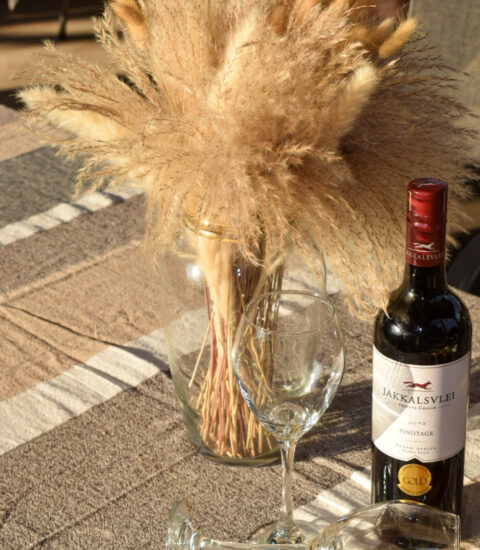 gallery with vase with decoration next to wine bottle and glasses