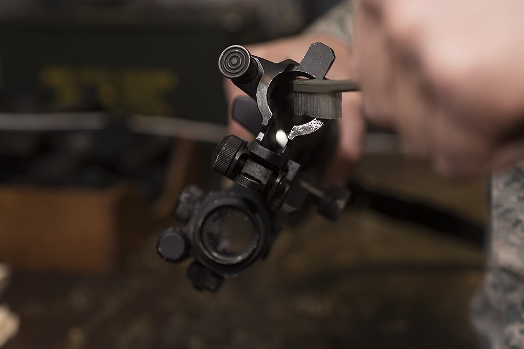rifle safety and preparation illustrated by hands cleaning rifle