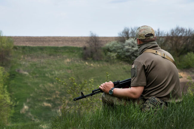 rifle safety and preparation illustrated by man holding rifle over lap