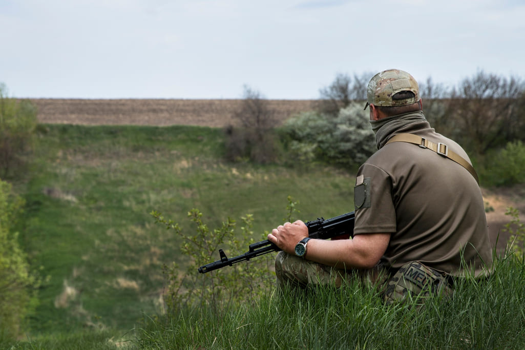 rifle safety and preparation illustrated by man holding rifle over lap