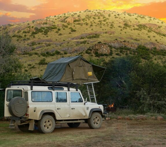 Preparing Your 4x4 for a safari with a 4x4 at a campsite next to a mountain at dusk