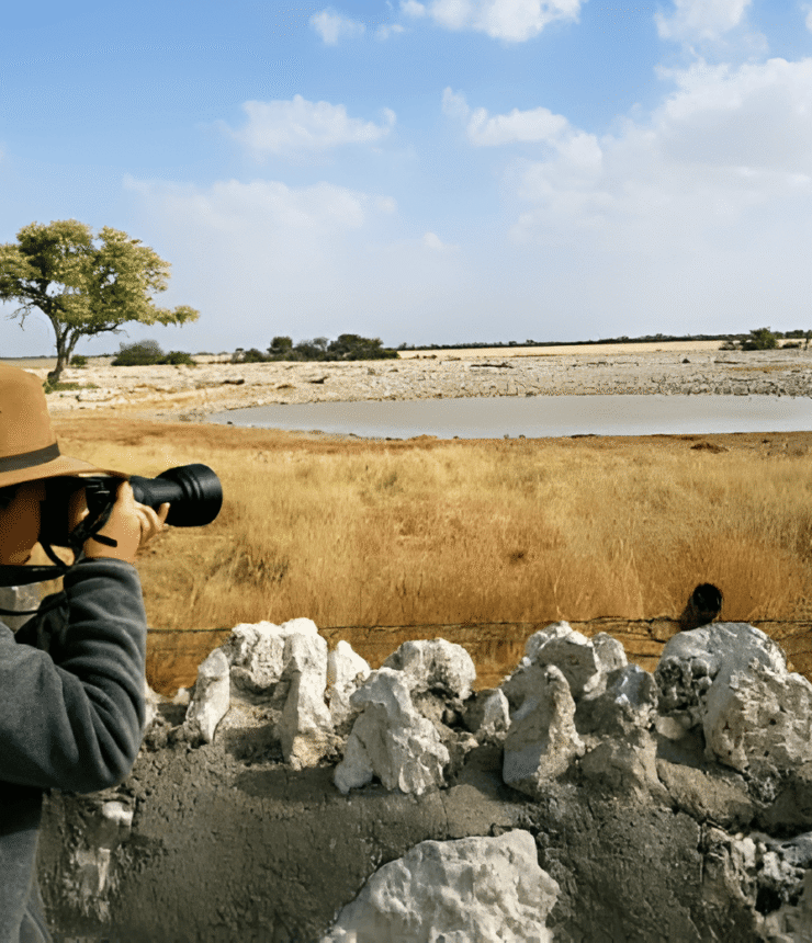 Capture Plains Game Portraits with photographer taking a picture of animals at waterhole