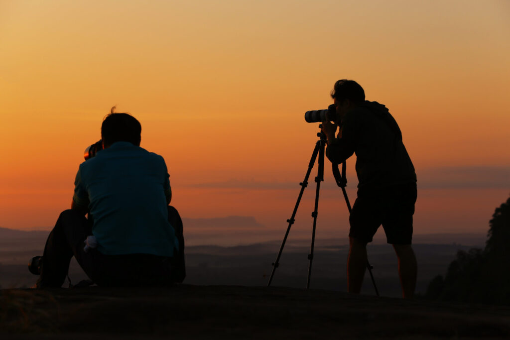 Capture Plains Game Portraits with photographer with friend at sunset using tripod